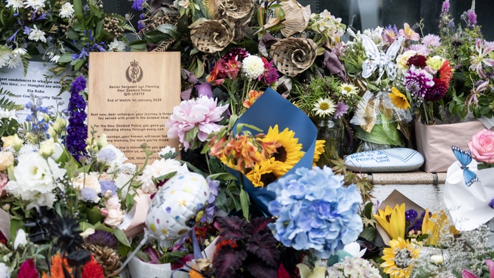Tributes for Senior Sergeant Lyn Fleming, left outside the Nelson Police Station. Photo / George Heard