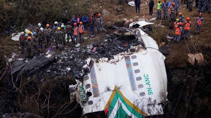 Rescuers scour the crash site of a passenger plane in Pokhara, Nepal earlier this month. The black boxes recovered from the crash is being sent to Singapore for analysis. Photo / AP