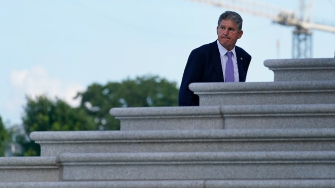 Sen. Joe Manchin, Democrat, walks up the steps of Capitol Hill in Washington. (Photo / AP)