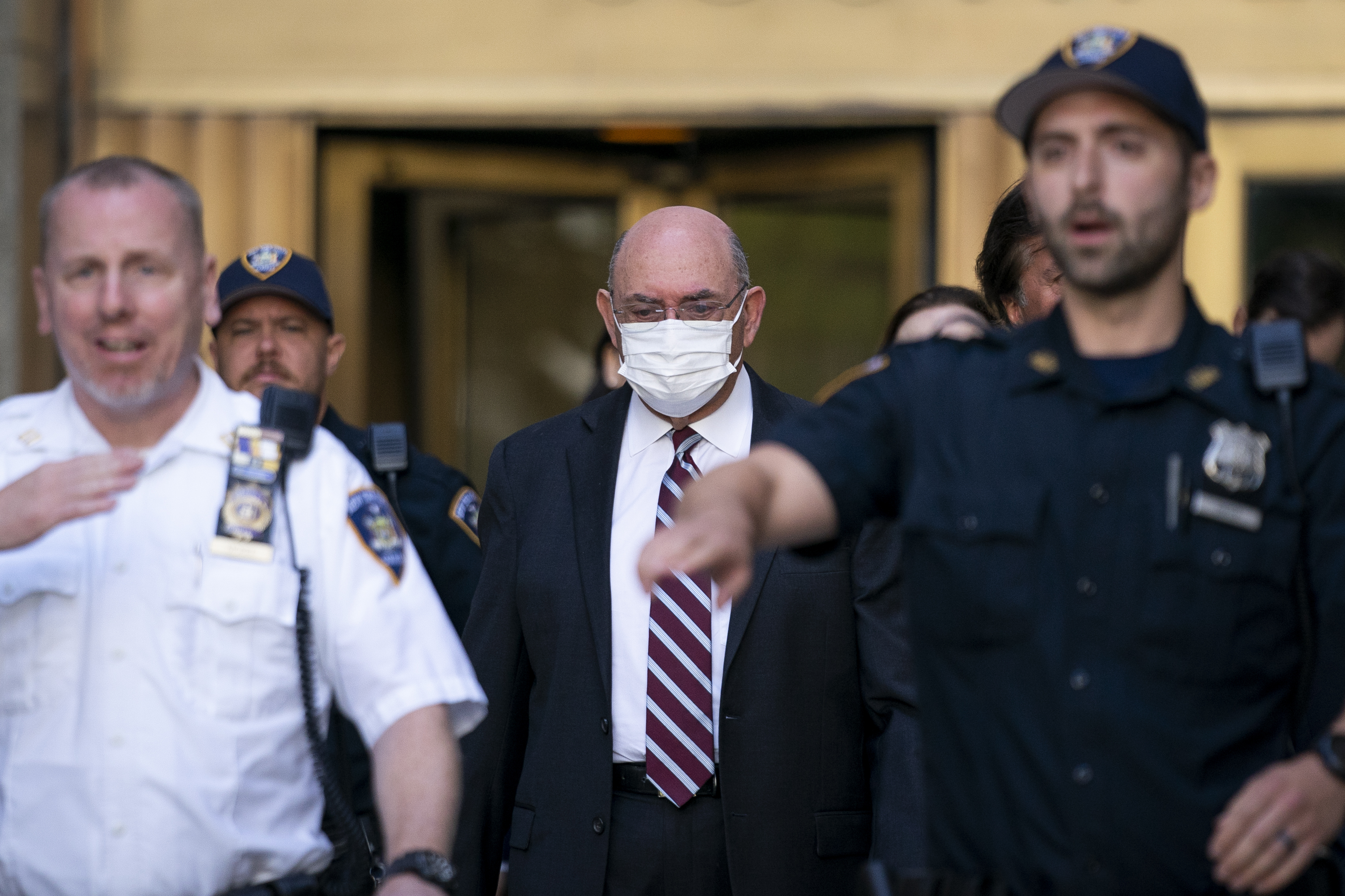 Law enforcement personnel escort the Trump Organization's former Chief Financial Officer Allen Weisselberg, center, as he departs court. Photo / AP