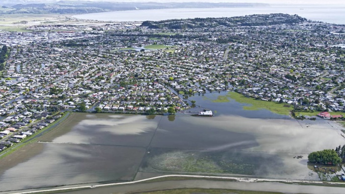 An aerial view of the November 2020 flood shows, at the bottom, the extent of flooding on the proposed housing development site. Photo / Peter Scott via RNZ