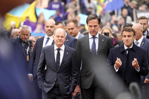 FILE - From left, Germany's Chancellor Olaf Scholz, Netherland's Prime Minister Mark Rutte and French President Emmanuel Macron arrive for an EU Summit at Prague Castle in Prague, Czech Republic, Friday, Oct 7, 2022. European Union leaders enter a crucial stretch this week to make sure runaway energy prices and short supplies do not further tank their struggling economies and foment unrest.(AP Photo/Darko Bandic, File)