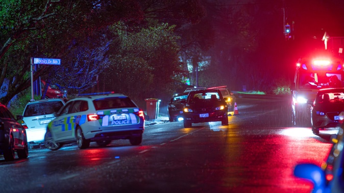 Police at the scene of the death on Moire Rd in Massey overnight. Photo / Hayden Woodward