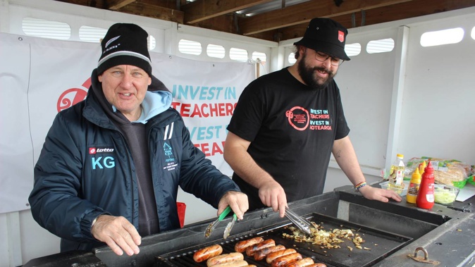 Kevin Greig, left, and Elliot Pilmore on lunchtime barbecue duty at Paraparaumu College during the secondary school teachers' strike. Funds raised from the barbecue are going to the Kāpiti Community Foodbank. Photo / David Haxton