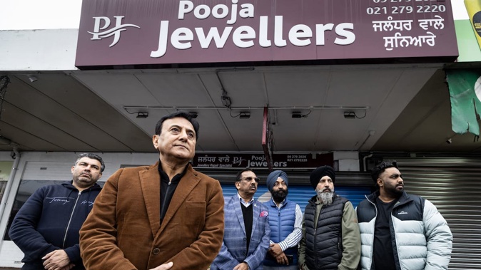 Local business and community leaders, including Sunny Kaushal, gather outside Pooja Jewellers after a violent aggravated robbery at the store. Photo / Jason Oxenham