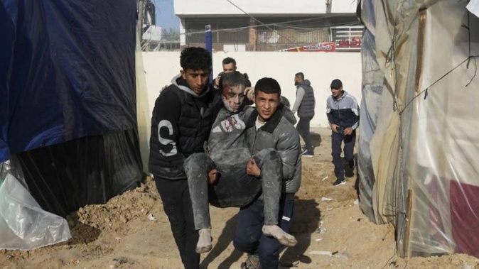 Palestinians evacuate wounded after an Israeli strike hit a building next to the Al-Aqsa Hospital in Deir al-Balah, Gaza Strip, on Wednesday, Jan 10, 2023. Photo / AP