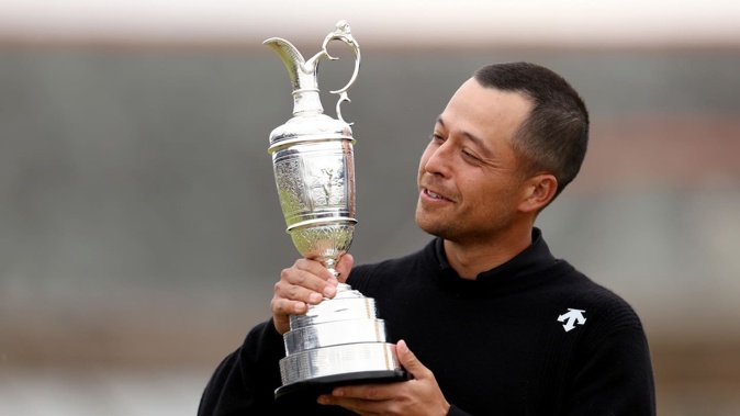 Xander Schauffele of the United States poses with the Claret Jug on the 18th hole in celebration of victory during day four of The 152nd Open championship. Photo / Getty Images