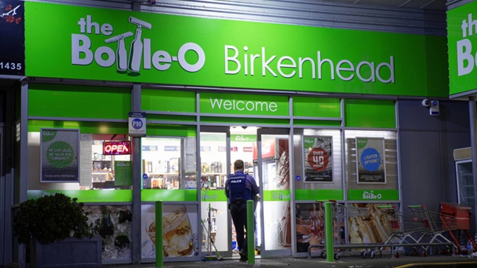 Police attending the scene of a robbery at a Birkenhead Bottle-O two nights before Christmas. Photo / Hayden Woodward