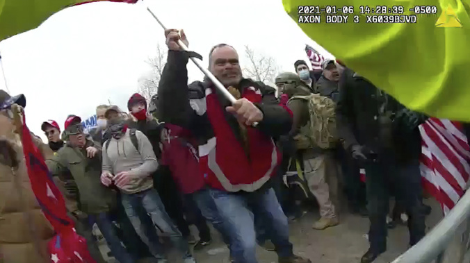 This still frame from Metropolitan Police Department body worn camera video shows Thomas Webster, in red jacket, at a barricade line at on the west front of the U.S. Capitol on Jan. 6, 2021. (Photo / AP)