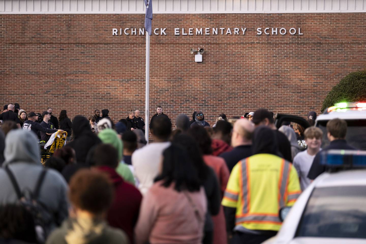 Students and police gather outside Richneck Elementary School after a shooting, with the accused - a child - in custody. Photo / AP