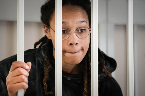 WNBA star and two-time Olympic gold medalist Brittney Griner speaks to her lawyers standing in a cage at a court room prior to a hearing, in Khimki just outside Moscow, Russia. Photo / AP