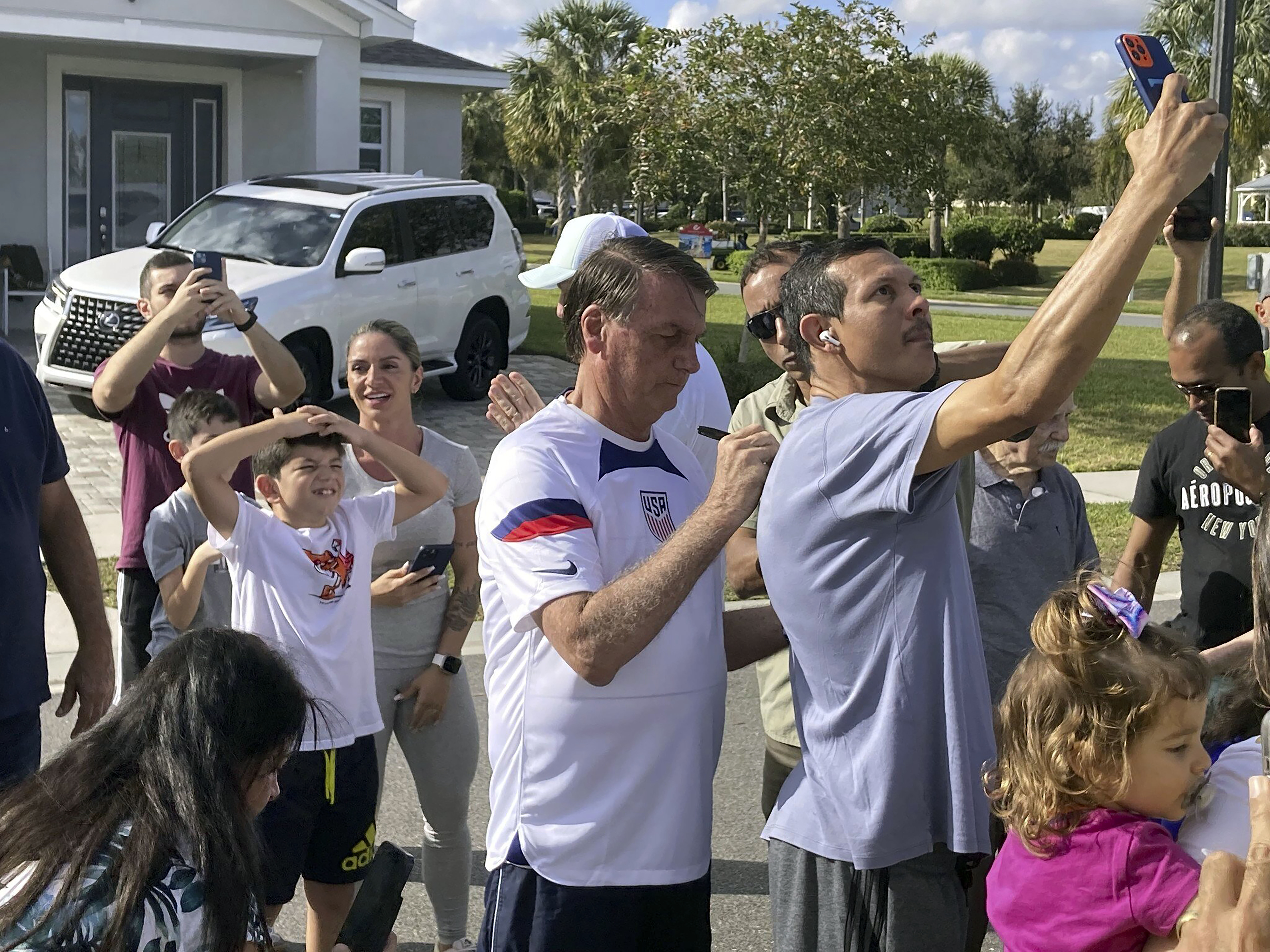 Former Brazil President Jair Bolsonaro, center, meets with supporters outside a vacation home where he is staying near Orlando, Fla., on Wednesday, Jan. 4, 2023.  Photo / AP
