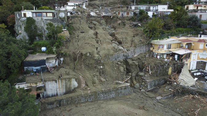 Authorities said that the landslide that early Saturday destroyed buildings and swept parked cars into the sea left one person dead and 12 missing. Photo / AP
