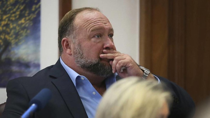 Alex Jones attempts to answer questions about his text messages asked by Mark Bankston, lawyer for Neil Heslin and Scarlett Lewis, during the trial in Austin. Photo / AP