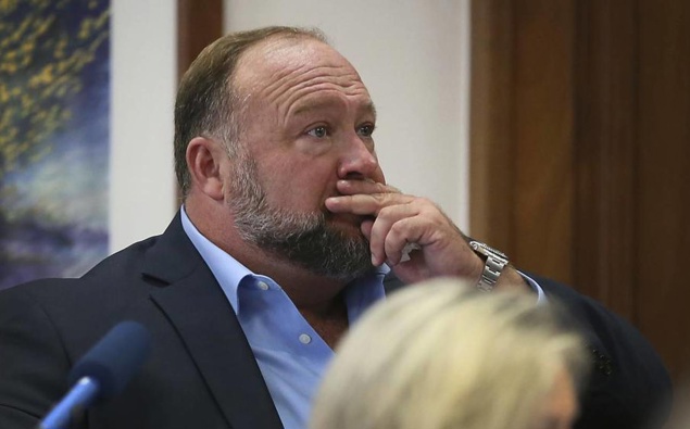 Alex Jones attempts to answer questions about his text messages asked by Mark Bankston, lawyer for Neil Heslin and Scarlett Lewis, during the trial in Austin. Photo / AP