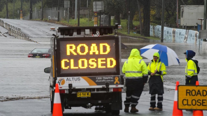Road closed in Chipping Norton, Sydney, as the Georges River rapidly rises. (Photo / news.com.au)