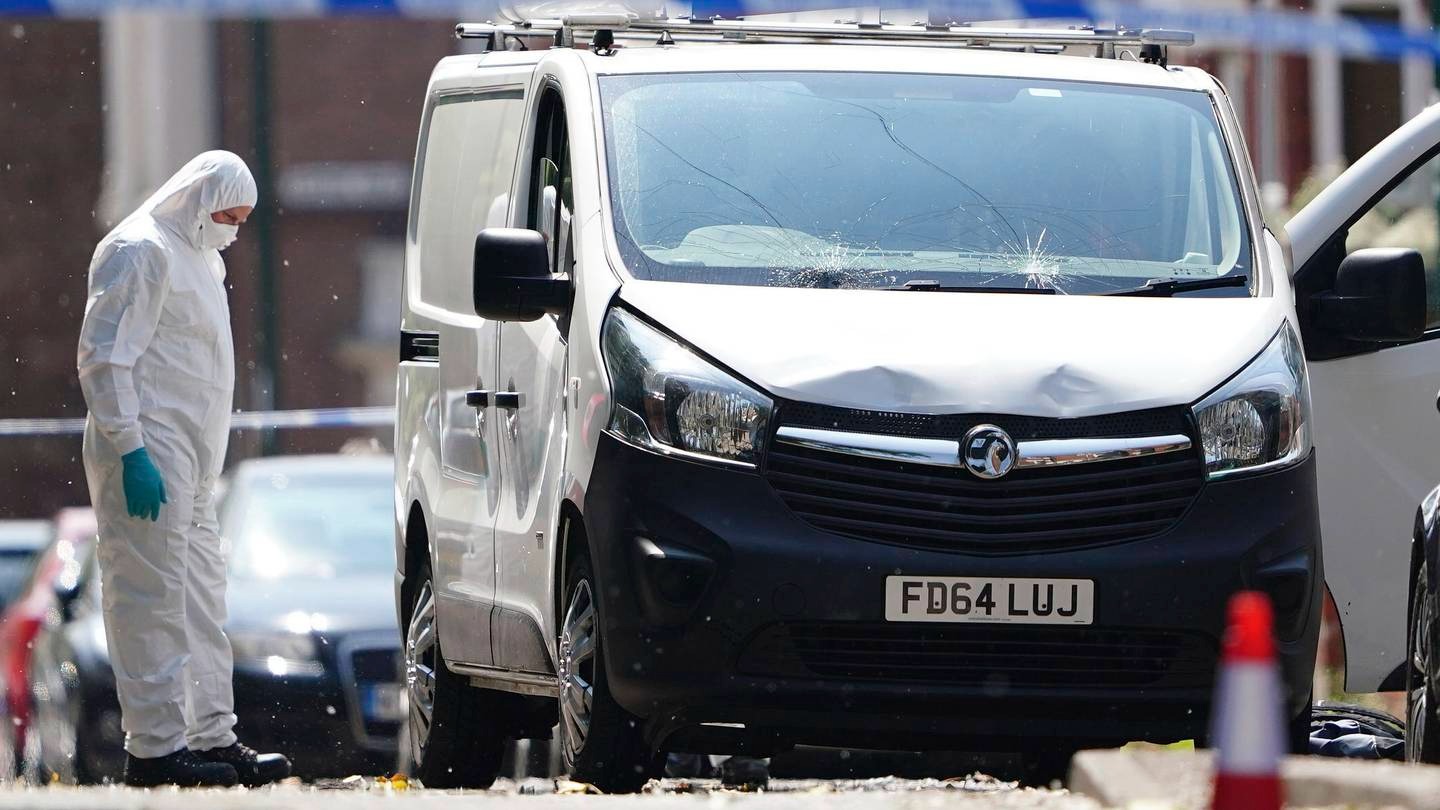 A police forensic officer searches a white van behind a police cordon in Nottingham city centre. Photo / AP