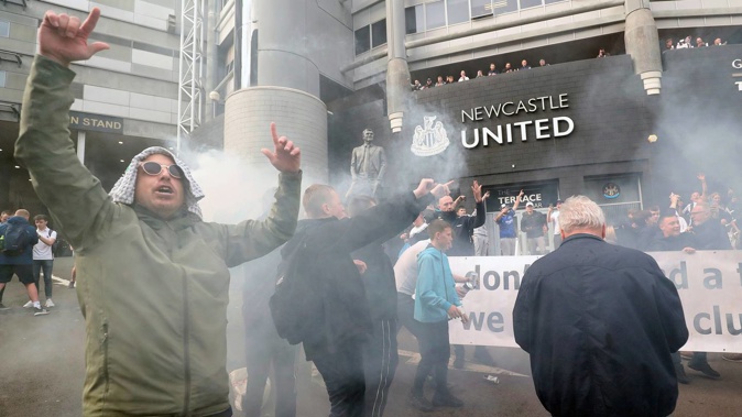 Newcastle fans celebrate the news that their club is now under new ownership. (Photo / AP)