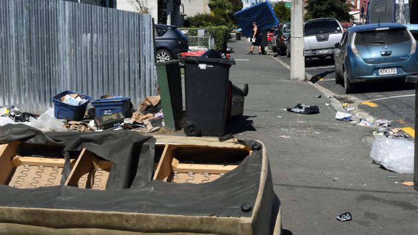 A mattress is delivered in Castle St near post-party debris after partygoers were notified they were potential close contacts of a Covid-19 case. (Photo / Stephen Jaquiery)