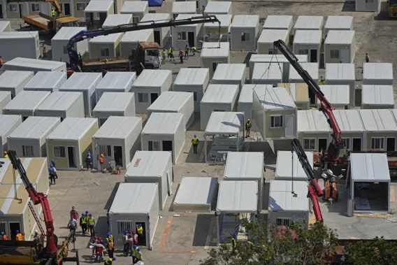 FILE - An aerial view shows a construction site of a new makeshift COVID-19 hospital and isolation facilities in Tsing Yi of Hong Kong, on Feb. 26, 2022. Hong Kong will scrap its mandatory isolation rule for people infected with COVID-19 from Jan. 30 as part of its strategy to return the southern Chinese city to normalcy, the city's leader said on Thursday, Jan. 19, 2023.(AP Photo/Kin Cheung, File)