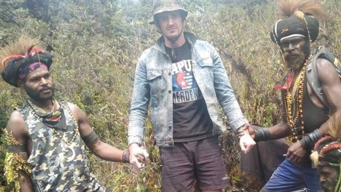 In this undated photo released by West Papua Liberation Army, the armed wing of the Free Papua Movement, Papuan separatist rebels pose for a photo with a man they said is New Zealander pilot Phillip Mark Mehrtens who they took hostage last week, at an undisclosed location in Papua province, Indonesia. Photo / AP