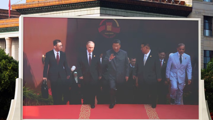 Xi Jinping, China's president, centre, Vladimir Putin, Russia's president, second left, and Kim Jong Un, North Korea's leader, second right, displayed on a screen at Tiananmen Square at a military parade to mark 80 years since Japan's defeat in World War II held in Beijing, China. Photo / Getty Images