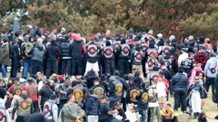 Hundreds of gang members at the tangi of William "Bird" Hines in Foxton in November 2023. Of the gangs pictured, the Head Hunters, Greazy Dogs and Nomads are subject to the current insignia ban under the new Gangs Act, but the Hu-Hu MC (member lower left) are not. Photo / Bevan Conley