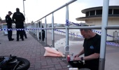 A member of the Jewish community lights a candle at the scene of the shooting at Bondi Beach in Sydney. Photo / David Gray, AFP