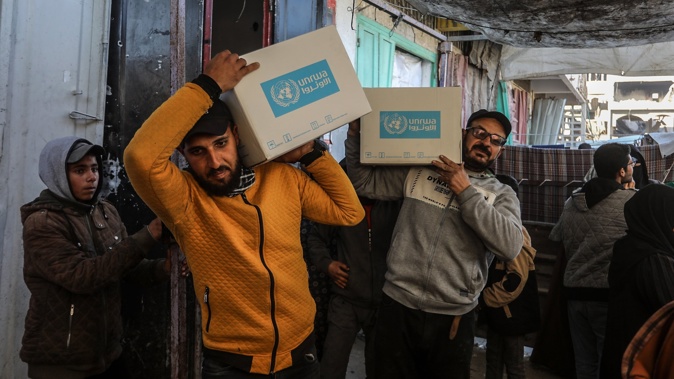 Displaced Palestinians receive emergency food parcels for families from The United Nations Relief and Works Agency for Palestine Refugees (UNRWA) centre in Khan Younis. Photo / Getty Images
