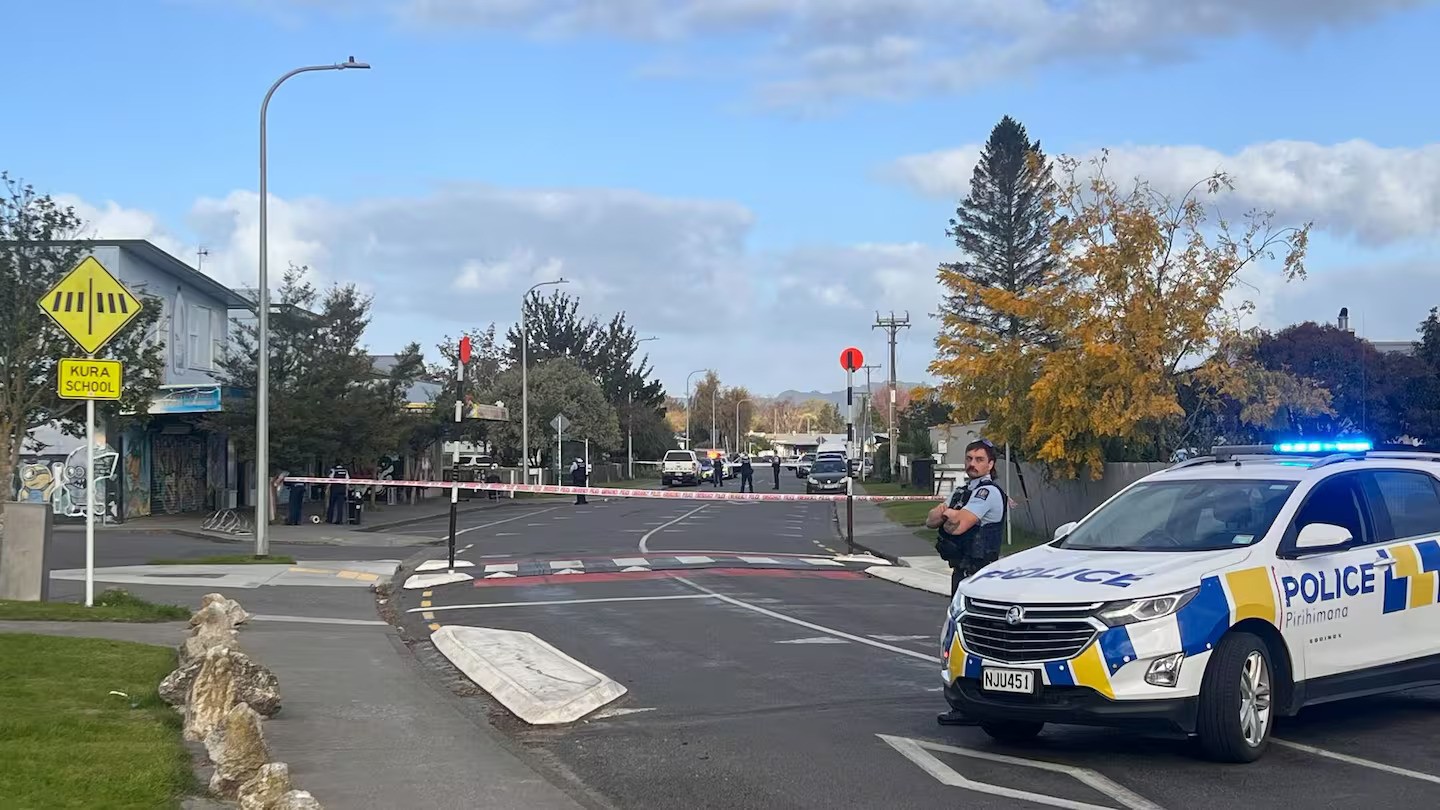A person has been taken into custody after armed police cordoned off a block of shops in Camberley. Photo / Rafaella Melo