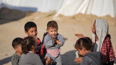 Palestinian children, displaced by the Israeli air and ground offensive on the Gaza Strip, play together at a makeshift tent camp in Deir al Balah. Photo / AP