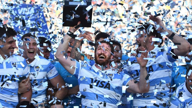 Julian Montoya of Argentina lifts the trophy with teammates after winning during a Rugby Championship match against Australia. Photo /Getty
