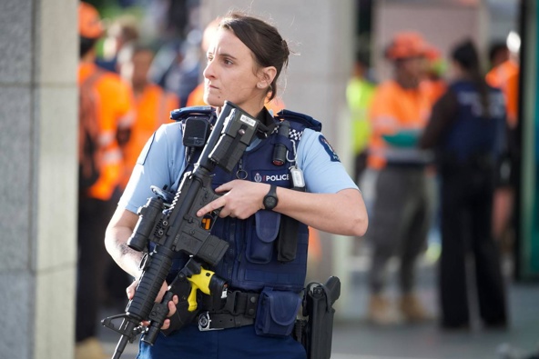 Armed police at the scene in downtown Auckland after a shooting incident which left multiple people dead yesterday. Photo / Jason Oxenham