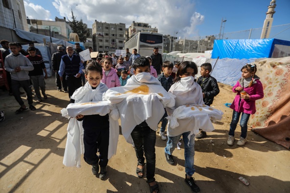Palestinian children march during a protest demanding an end to the war and their right to live, education and play on February 14, 2024 in Rafah, Gaza. /Getty