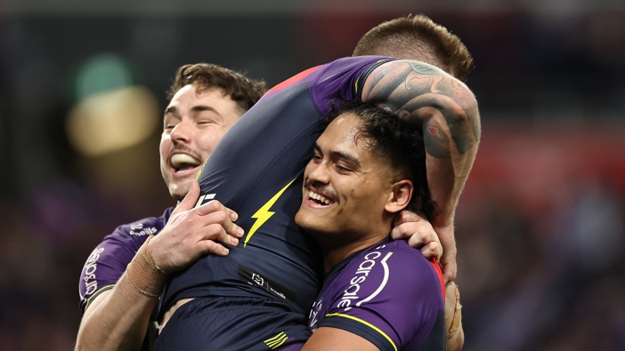 Cameron Munster of the Storm celebrates with team mates after scoring a try during the NRL Preliminary Final match between the Melbourne Storm and Sydney Roosters at AAMI Park on September 27, 2024 in Melbourne, Australia. (Photo by Cameron Spencer/Getty Images)