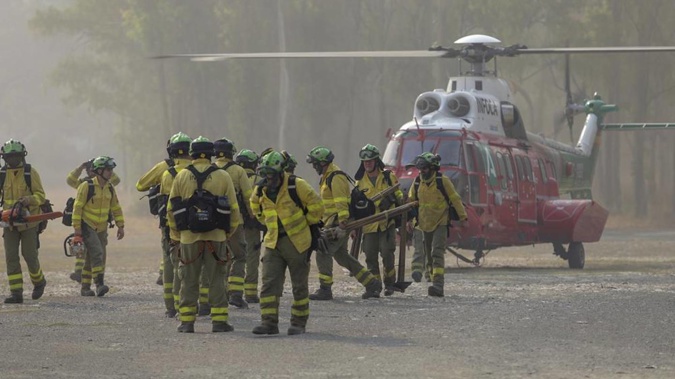 Emergency services deployed almost 1000 firefighters, military personnel and support crews to fight a wildfire that has forced the evacuation of some 2000 people in southern Spain. Photo / AP