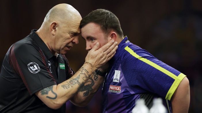 Match referee Russ Bray (left) speaks with Luke Littler at the end of the penultimate set of the World Darts Championship final between Luke Littler and Luke Humphries on day sixteen of the 2023/24 PDC World Darts Championship at Alexandra Palace on 3rd January 2024 in London, England (Photo by Tom Jenkins/Getty Images)