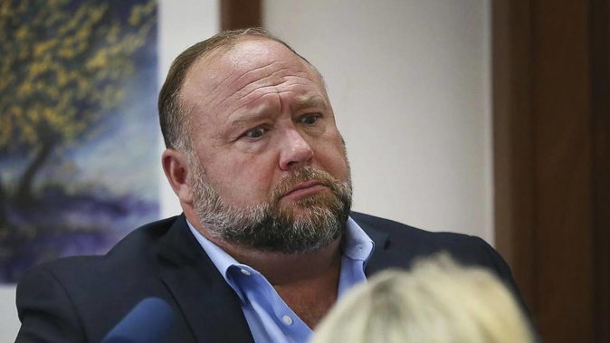 Conspiracy theorist Alex Jones attempts to answer questions about his emails asked by Mark Bankston, lawyer for Neil Heslin and Scarlett Lewis, during trial. Photo / AP