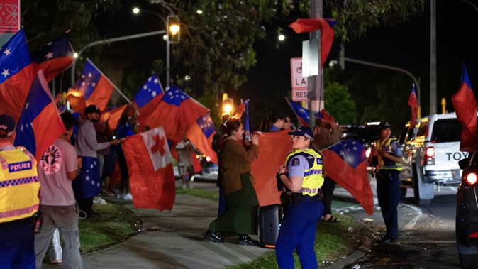 Samoan fans celebrate after Toa Samoa's historic win over England on Sunday morning. Photo / Hayden Woodward