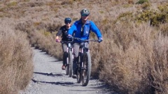 The tourists biking out from the Tongariro Alpine Crossing. Photo / D Van der Lubbe, DoC