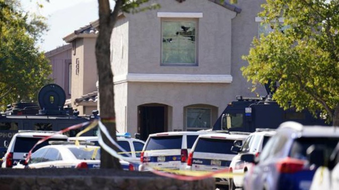 Five police officers were shot after responding to a report of gunfire inside a home, while trying to take a baby to safety. Photo / AP