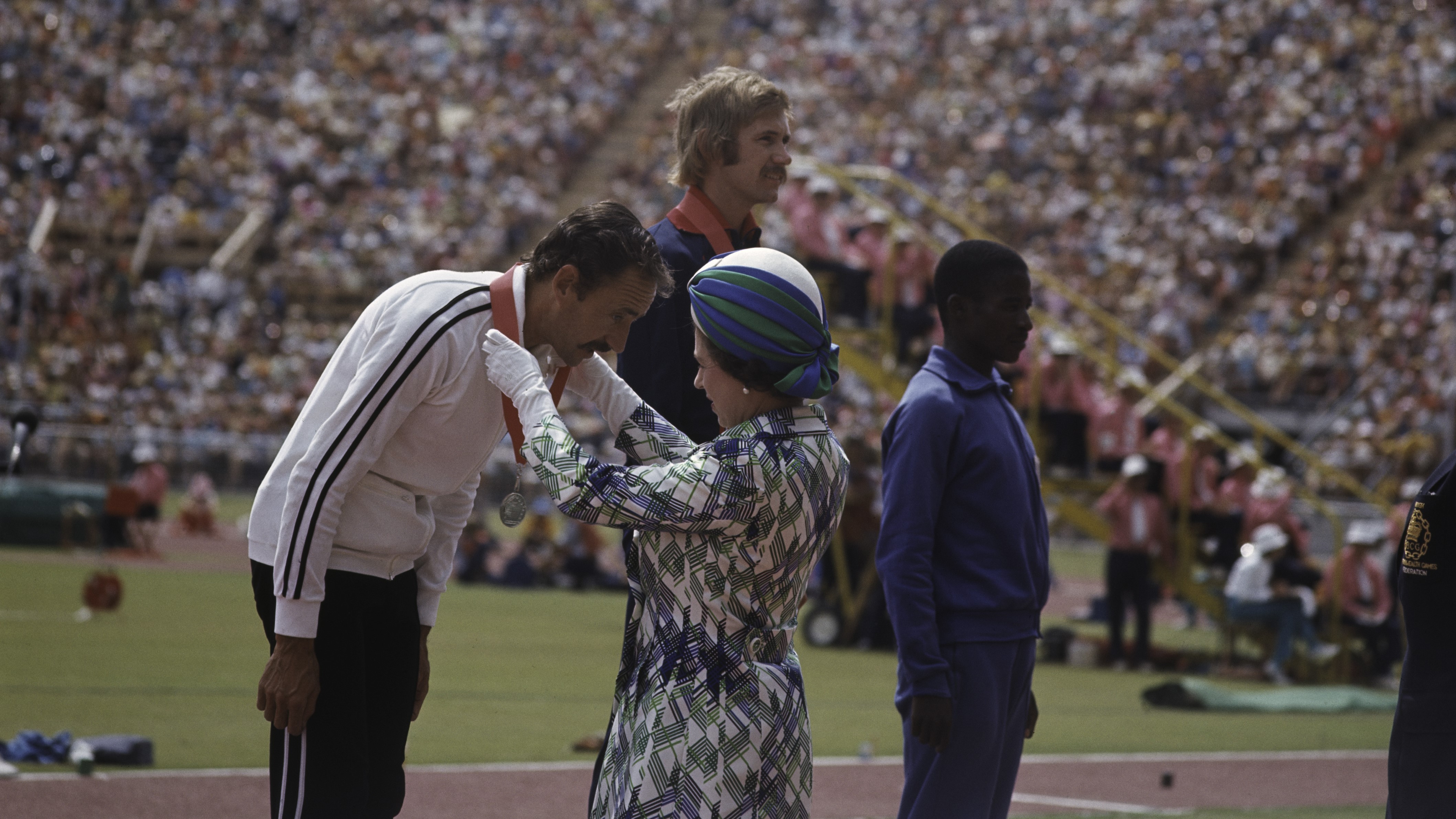 Queen Elizabeth II presents the medals to the winners at the Commonwealth Games in Christchurch, New Zealand, February 1974. (Photo by Hulton Archive/Getty Images)