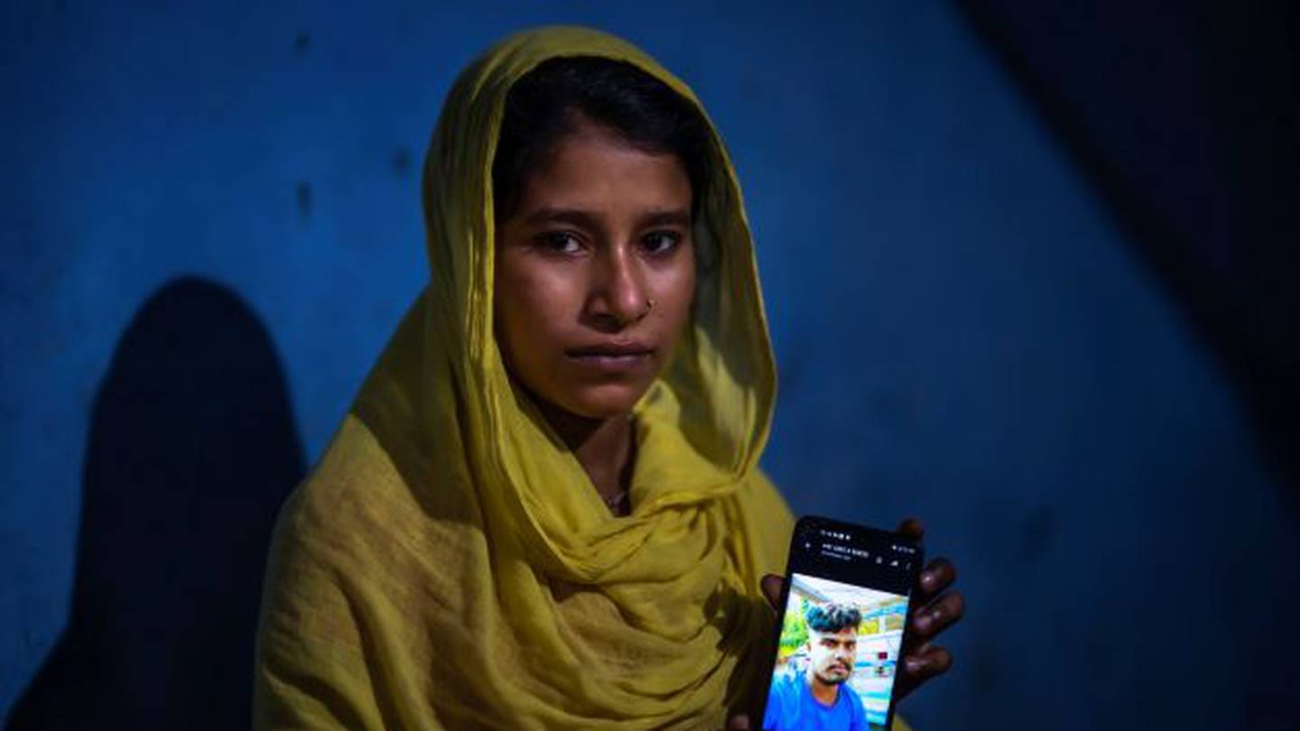 Sonali Begum, 17, displays a photo of her husband Siddique Ali, 23, who was picked up by the police in a crackdown on illegal child marriages. Begum is seven months pregnant. Photo / AP