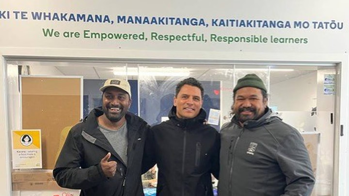 Doug Howlett (middle) at Wesley Primary School with principal Lou Reddy (left) and a volunteer. Photo / Supplied