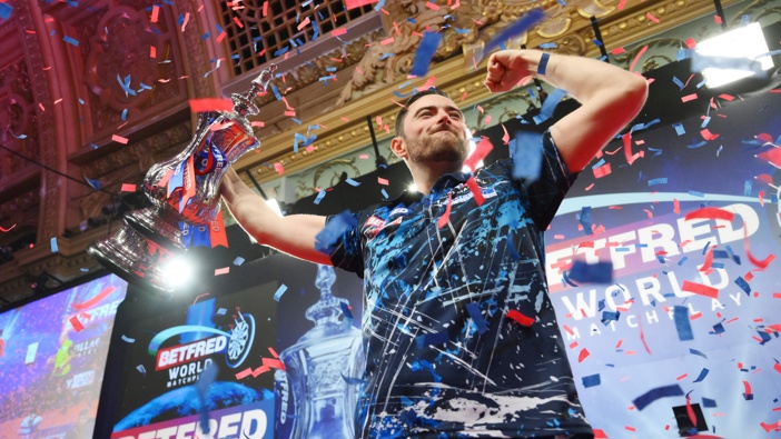 Luke Humphries of England celebrates with the Men's 2024 Betfred World Matchplay Finals trophy following the win against Michael Van Gerwen of Netherlands during the Final of the Men's 2024 Betfred World Matchplay Finals at Winter Gardens on July 21, 2024 in Blackpool, England. (Photo by Ben Roberts Photo/Getty Images)