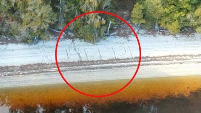 A passing helicopter spotted this 'HELP' message written in the sand next to Lake Ahaura, on the West Coast. Photo / Supplied