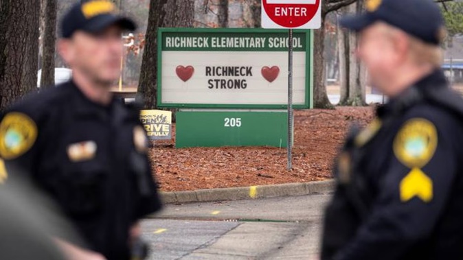 Police look on as students return to Richneck Elementary in Newport News, Virginia, at the end of January after a 6-year-old boy shot his teacher. Photo / via AP