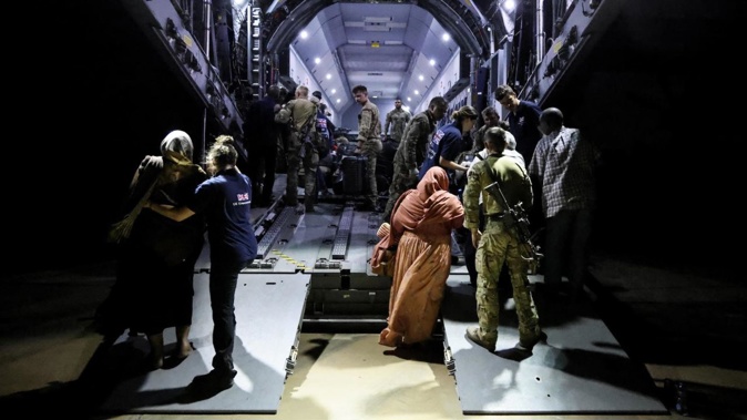 British citizens seen boarding an RAF aircraft in Sudan for evacuation to Cyprus.