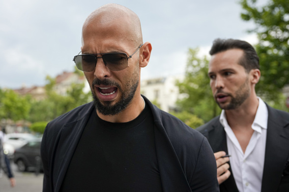 Andrew Tate, left, and his brother Tristan, right, talk to media after exiting the Court of Appeals building in Bucharest, Romania, Thursday, May 30, 2024. (AP Photo/Andreea Alexandru)