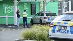 Police outside the Hobsonville Woolworths on Tuesday afternoon. Photo / RNZ, Calvin Samuel